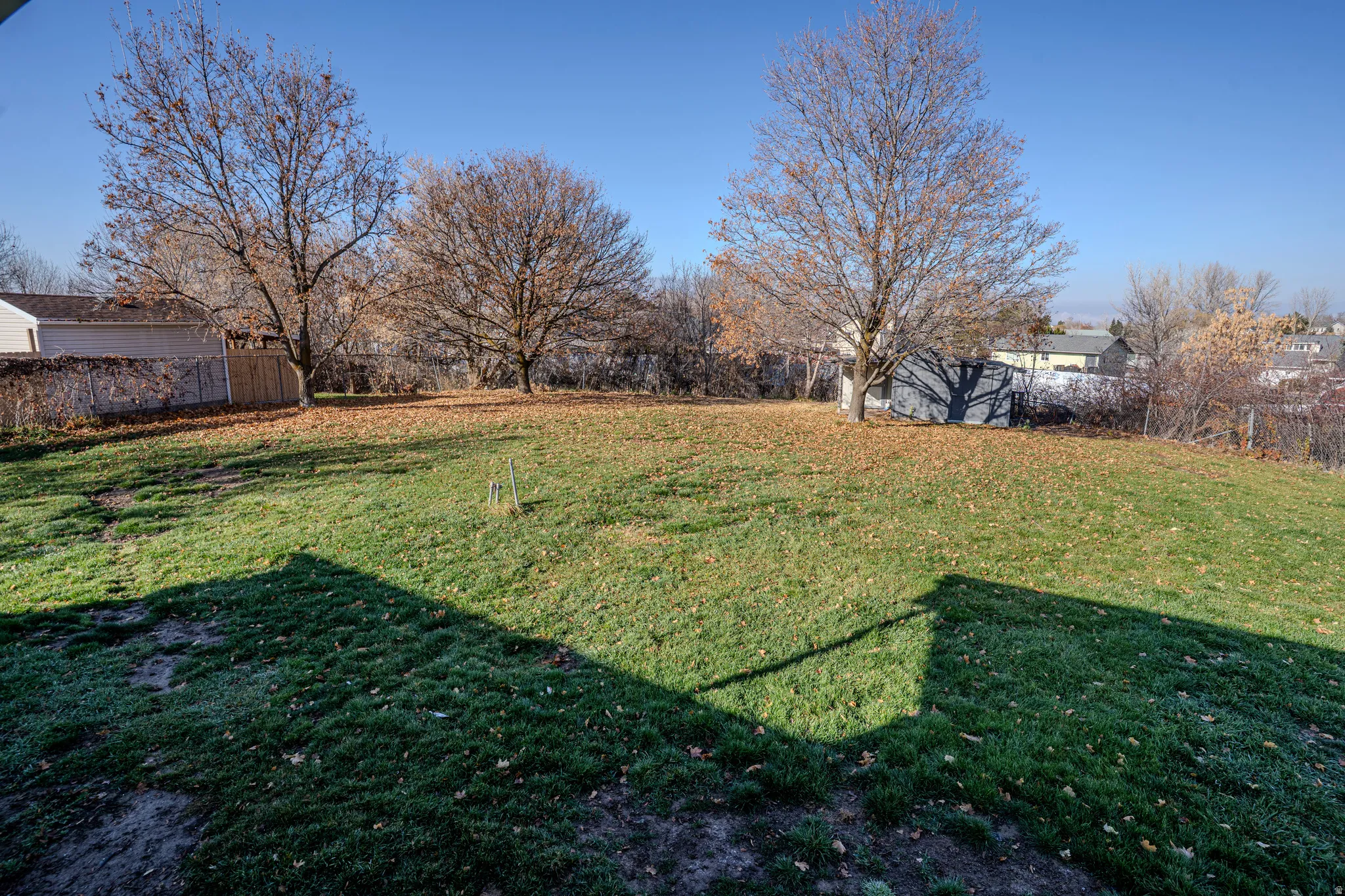 View of the fully fenced back yard with mature landscaping, almost 9,000 sq feet.