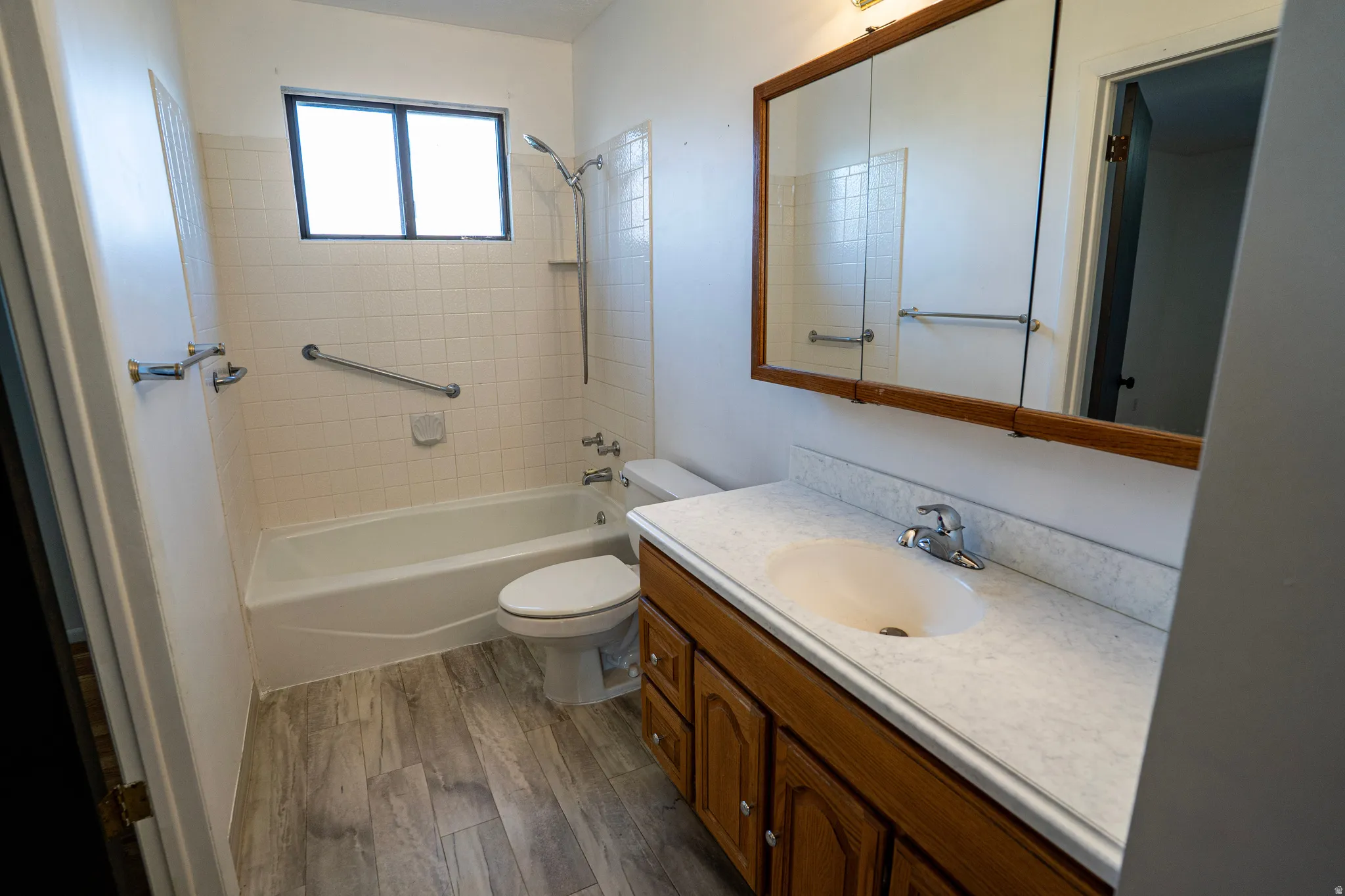 Primary Bathroom (upstairs) featuring vanity, laminate wood-type flooring, and bathtub shower combination