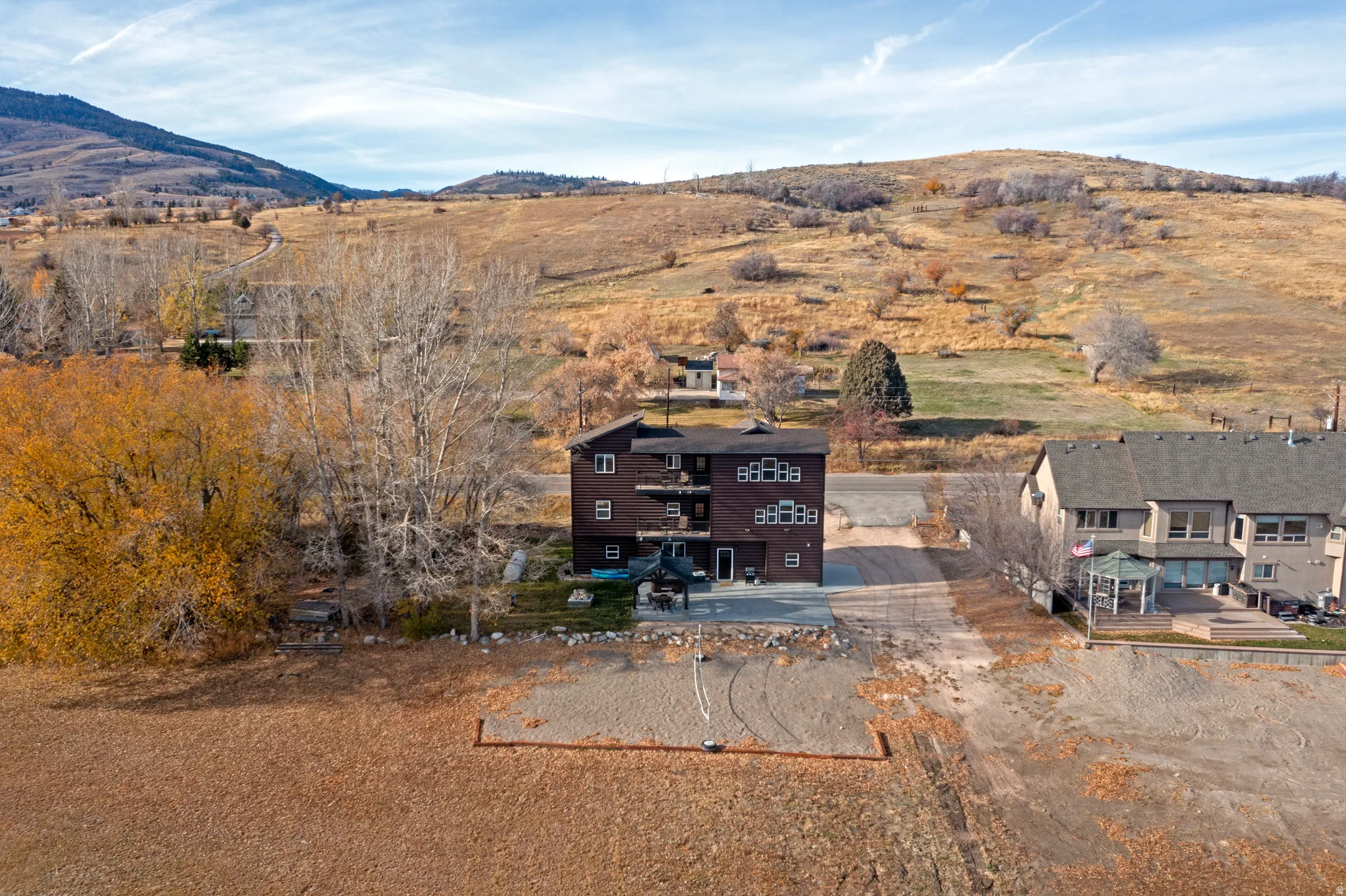 Aerial view of property and surrounding area with a mountainous background