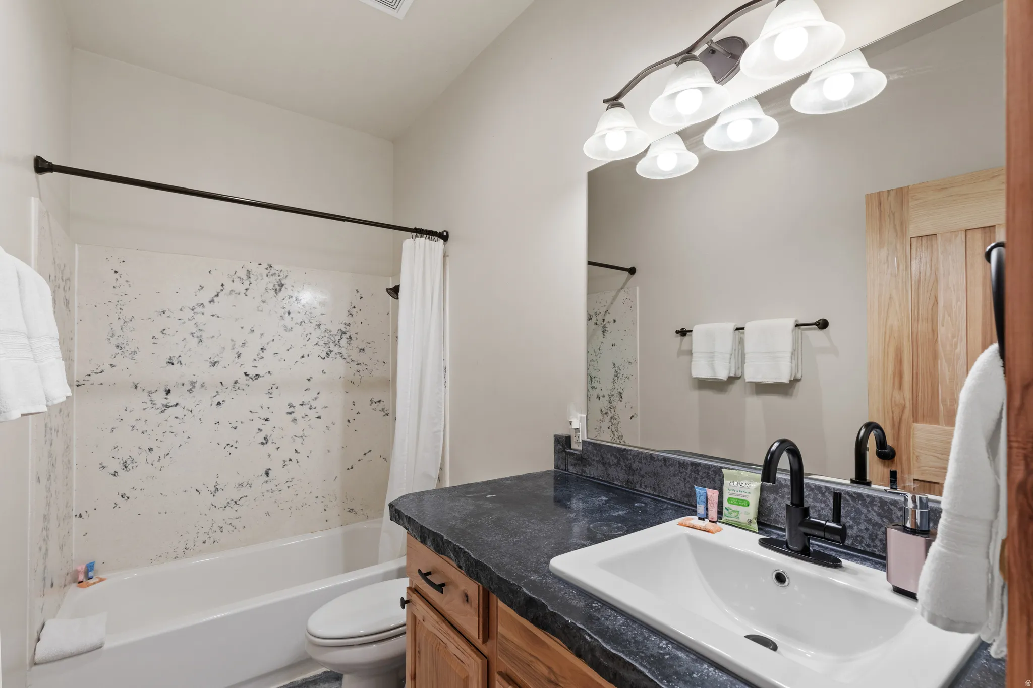 Bathroom featuring shower / bath combo and vanity