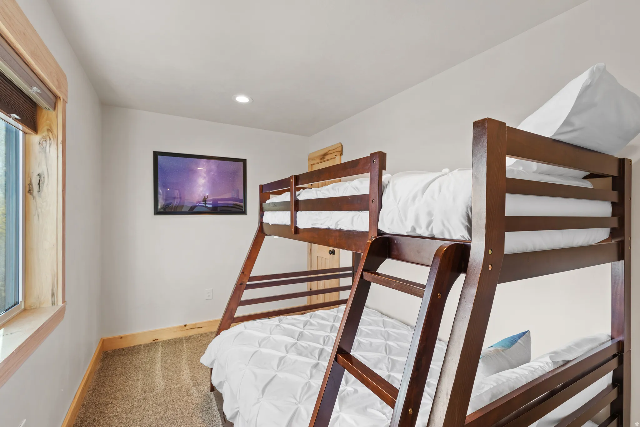 Carpeted bedroom with baseboards and recessed lighting