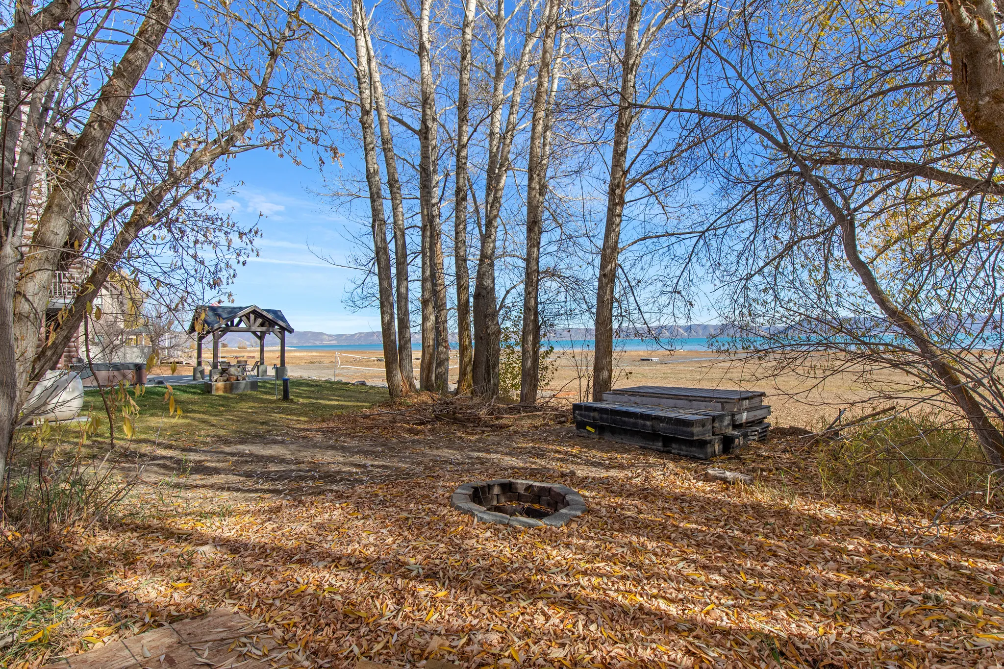 View of yard with an outdoor fire pit and a patio area