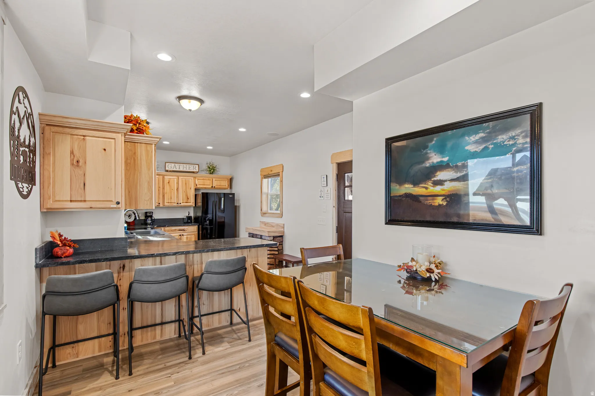 Dining space with recessed lighting and light wood finished floors
