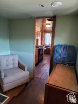 Sitting room featuring dark wood-style flooring