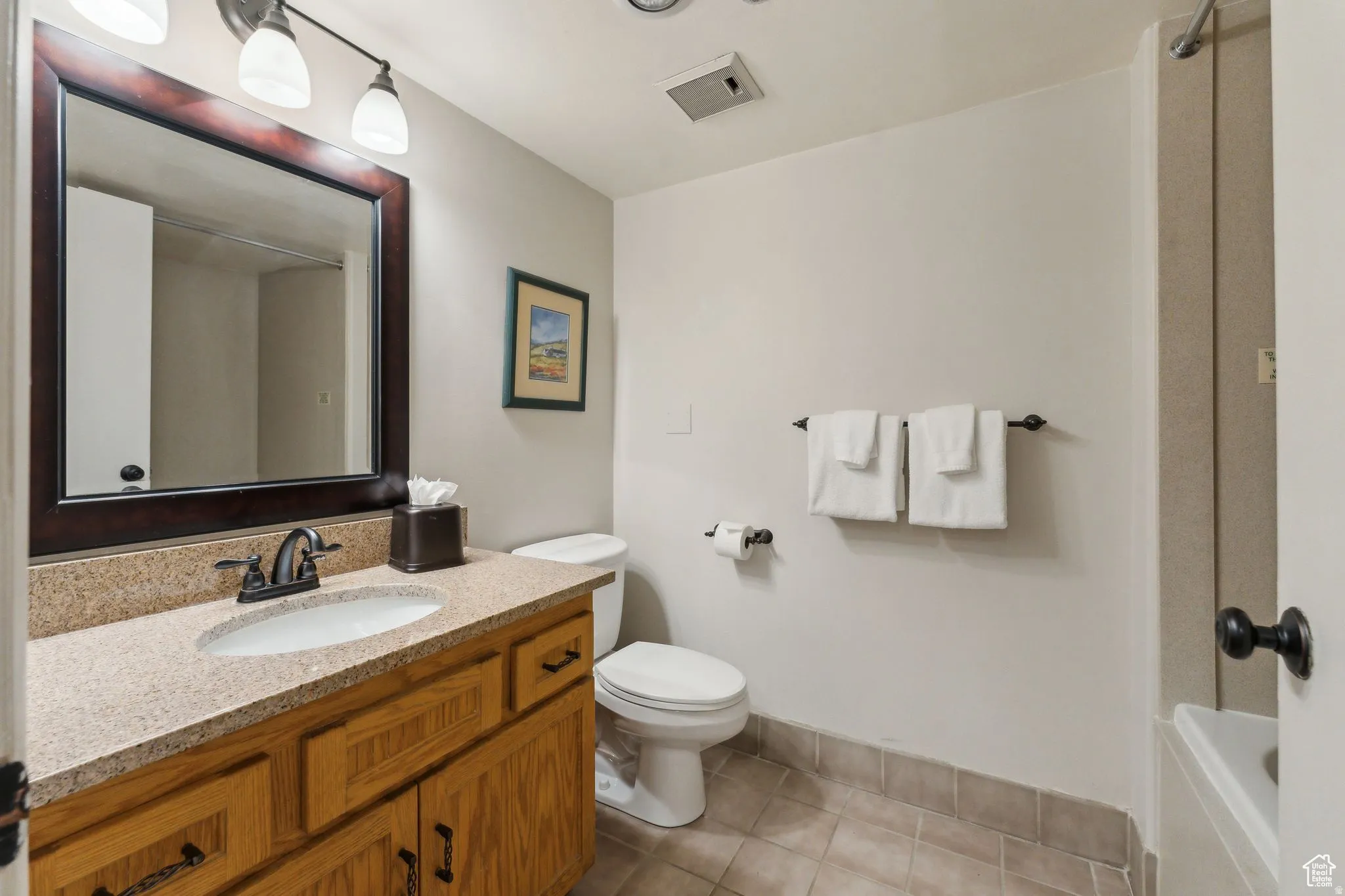 Bathroom with vanity and light tile patterned floors