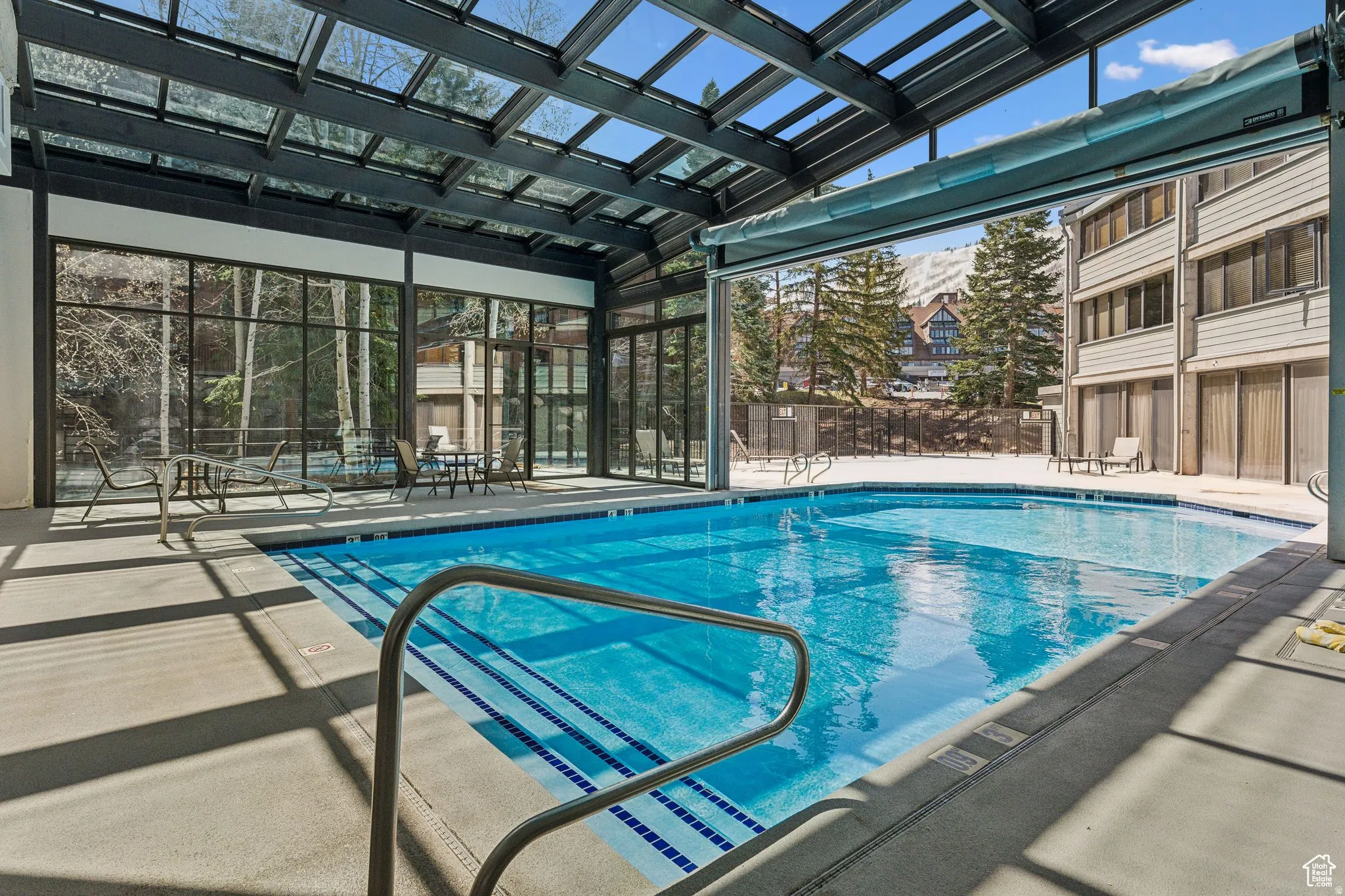 Community pool featuring a patio area and a sunroom