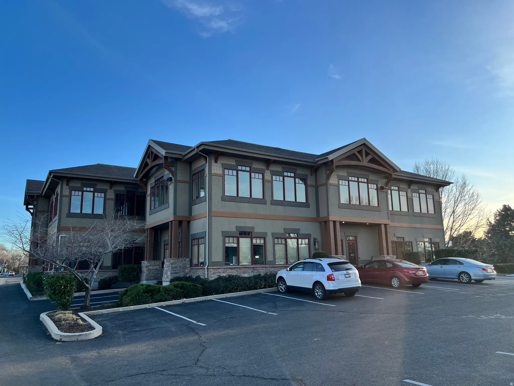 View of building exterior featuring uncovered parking