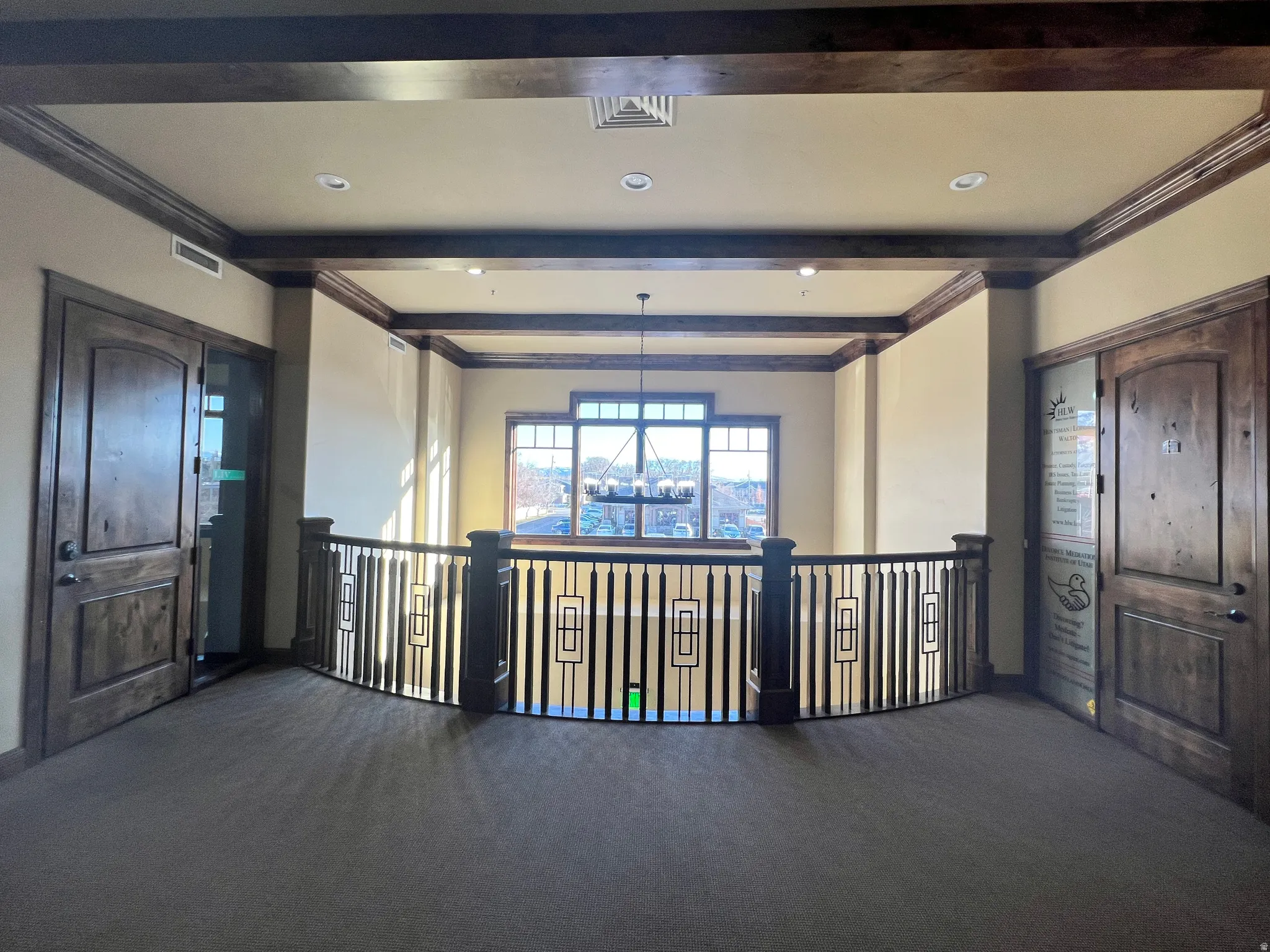 Hall with beamed ceiling, carpet, ornamental molding, a chandelier, and recessed lighting