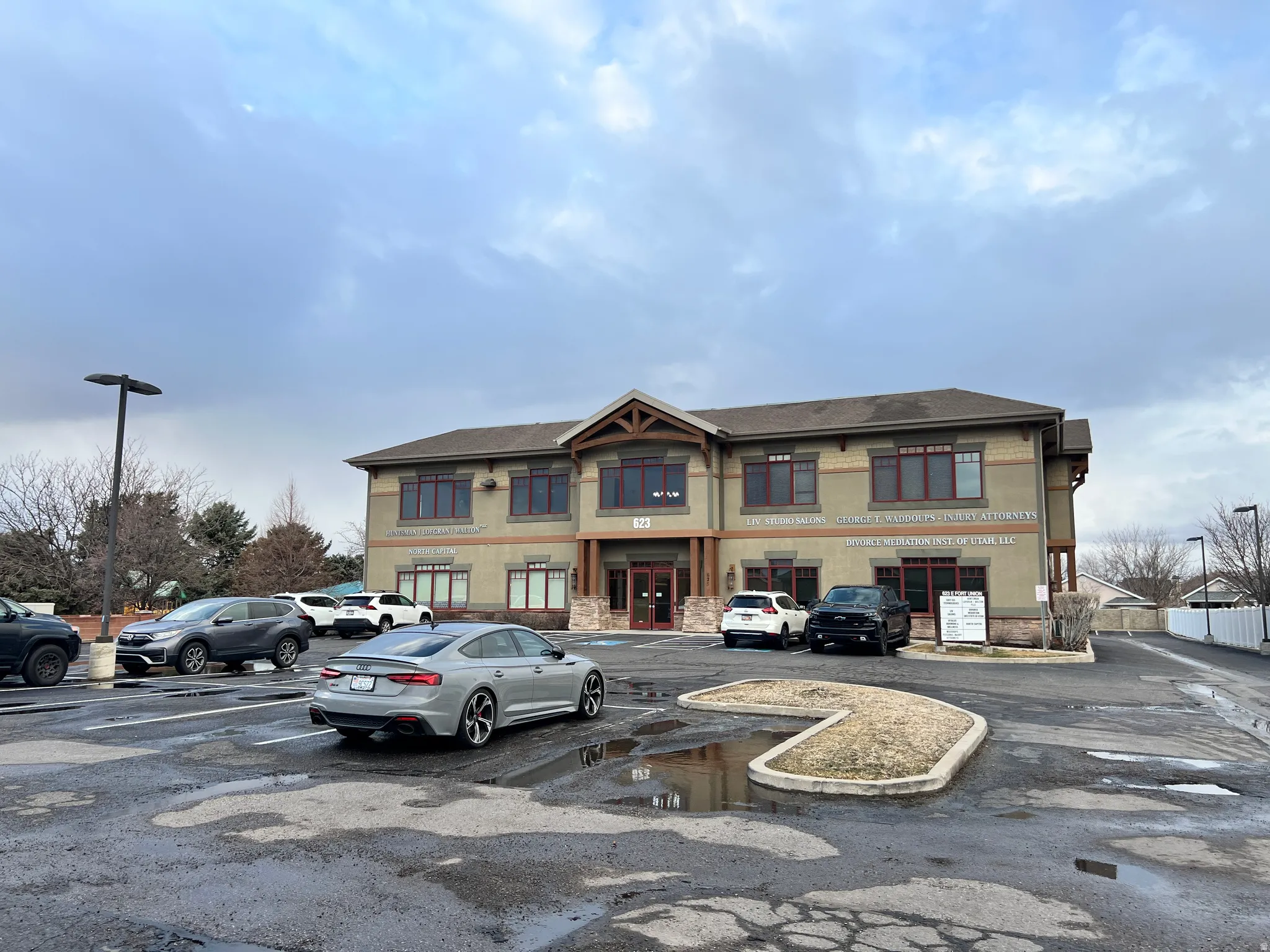 View of front of home featuring uncovered parking and stucco siding