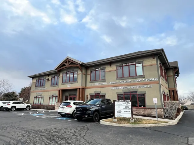 View of building exterior featuring uncovered parking
