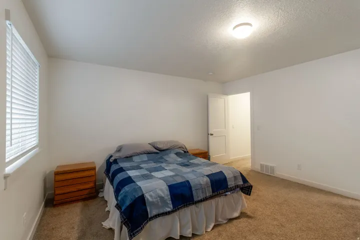 Bedroom with carpet and a textured ceiling