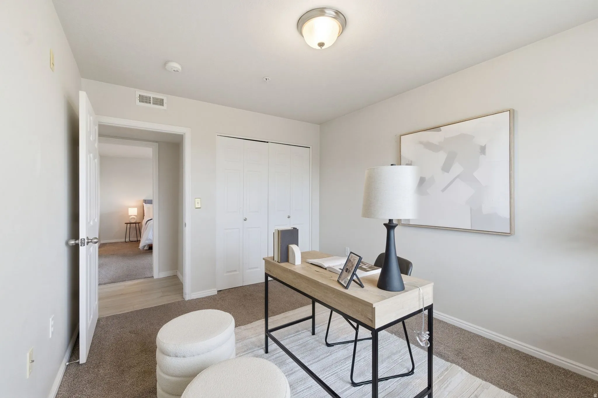Bedroom featuring neutral tone walls complement the carpeted flooring