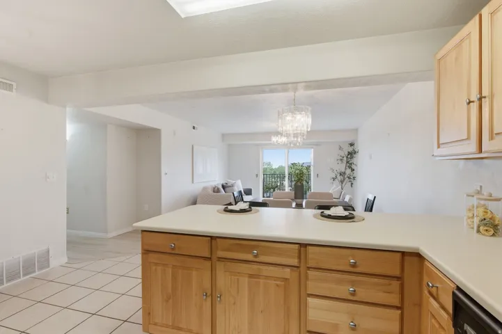 Kitchen island with light-toned cabinetry and a light-colored countertop