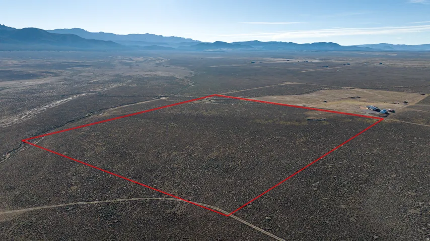 Overview of rural landscape featuring property parcel outlined and a mountainous background