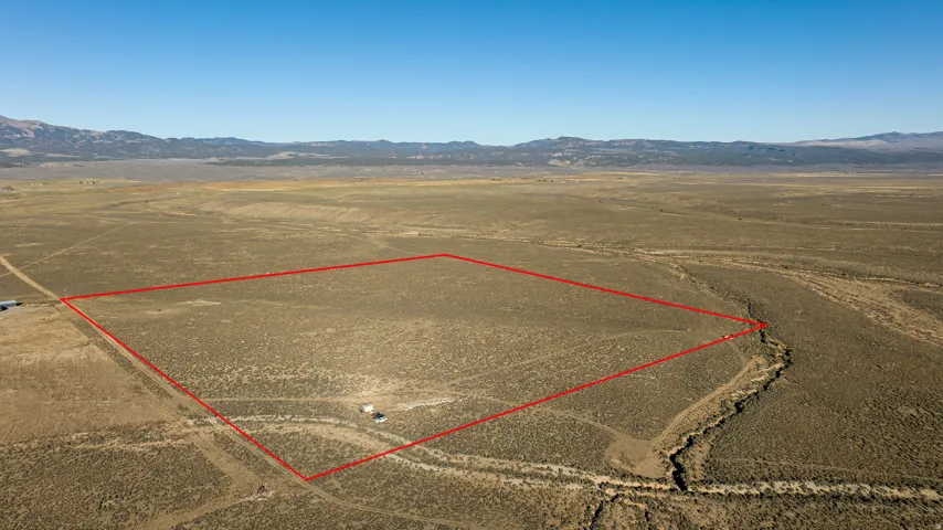 Aerial view of sparsely populated area featuring mountains and property boundaries highlighted