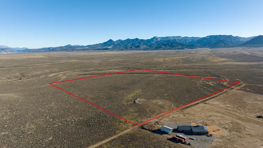 View of rural area featuring a mountain backdrop and property parcel outlined