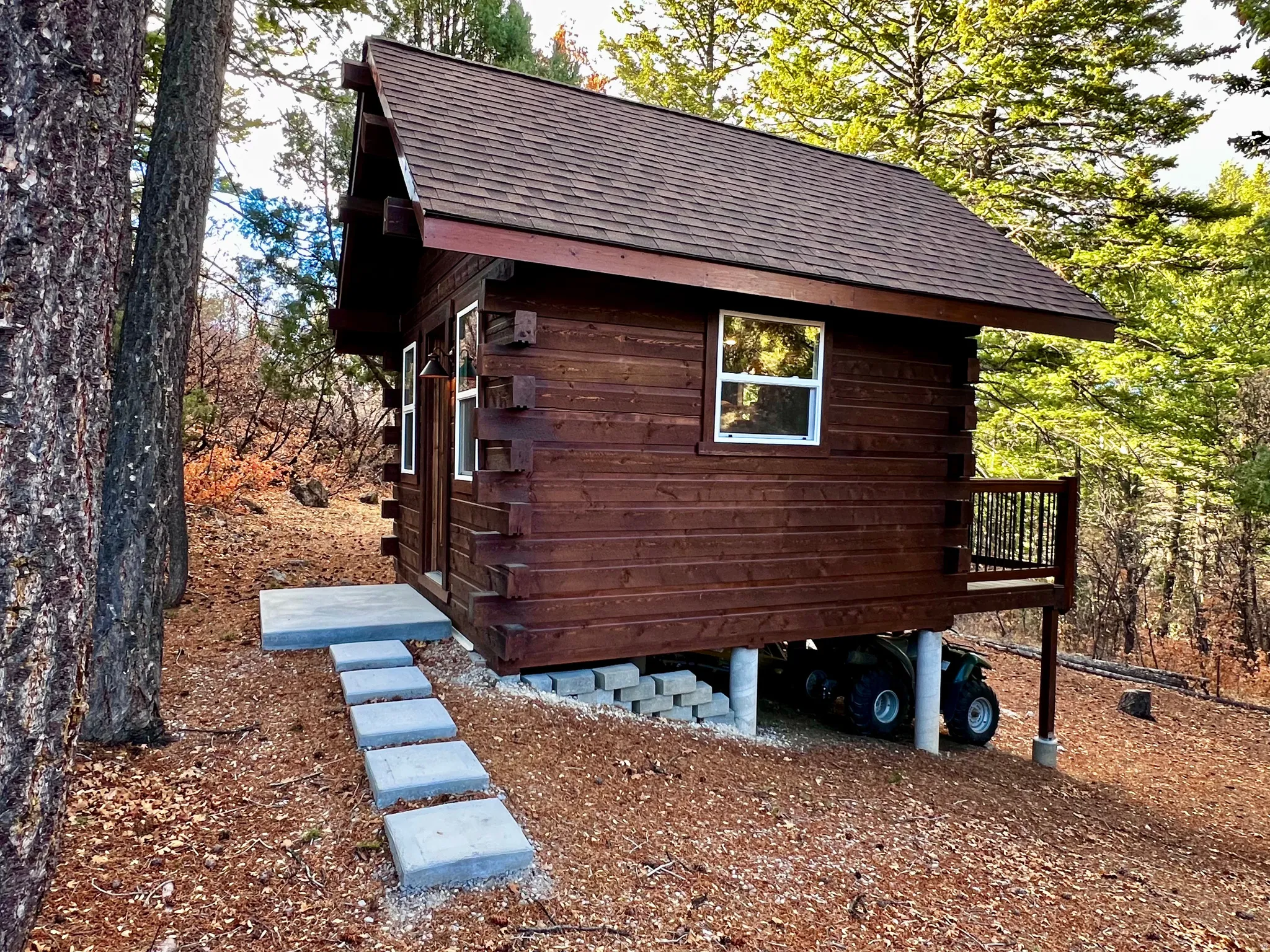 View of home's exterior with a shingled roof and a deck