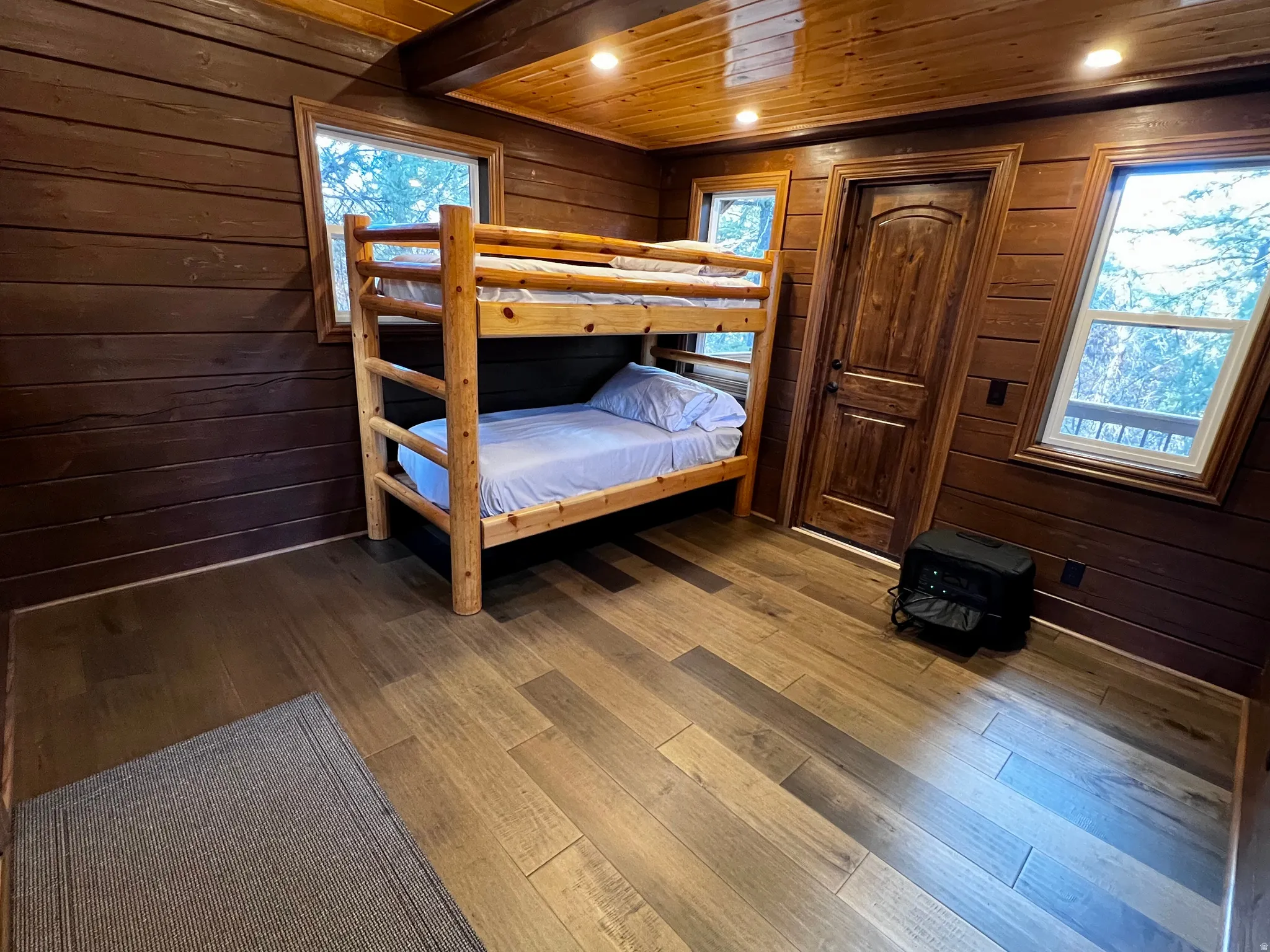Bedroom with wood walls, wood ceiling, hardwood / wood-style flooring, and recessed lighting