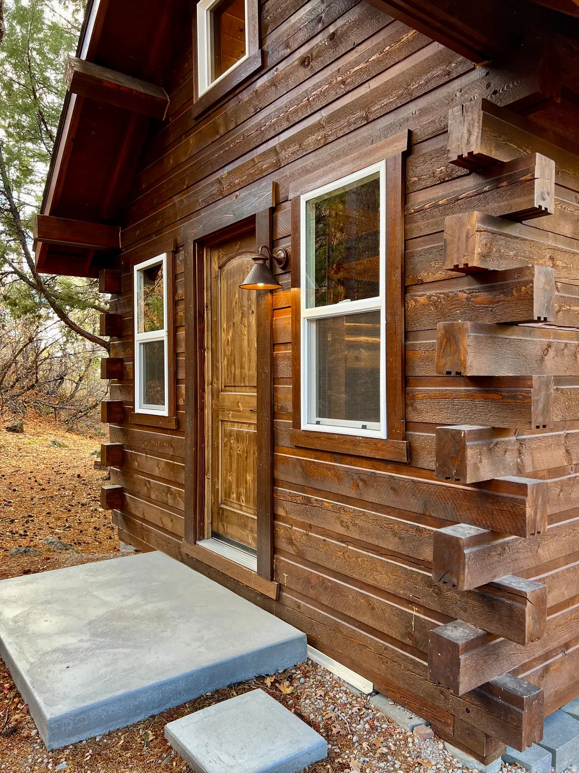 Property entrance featuring log siding