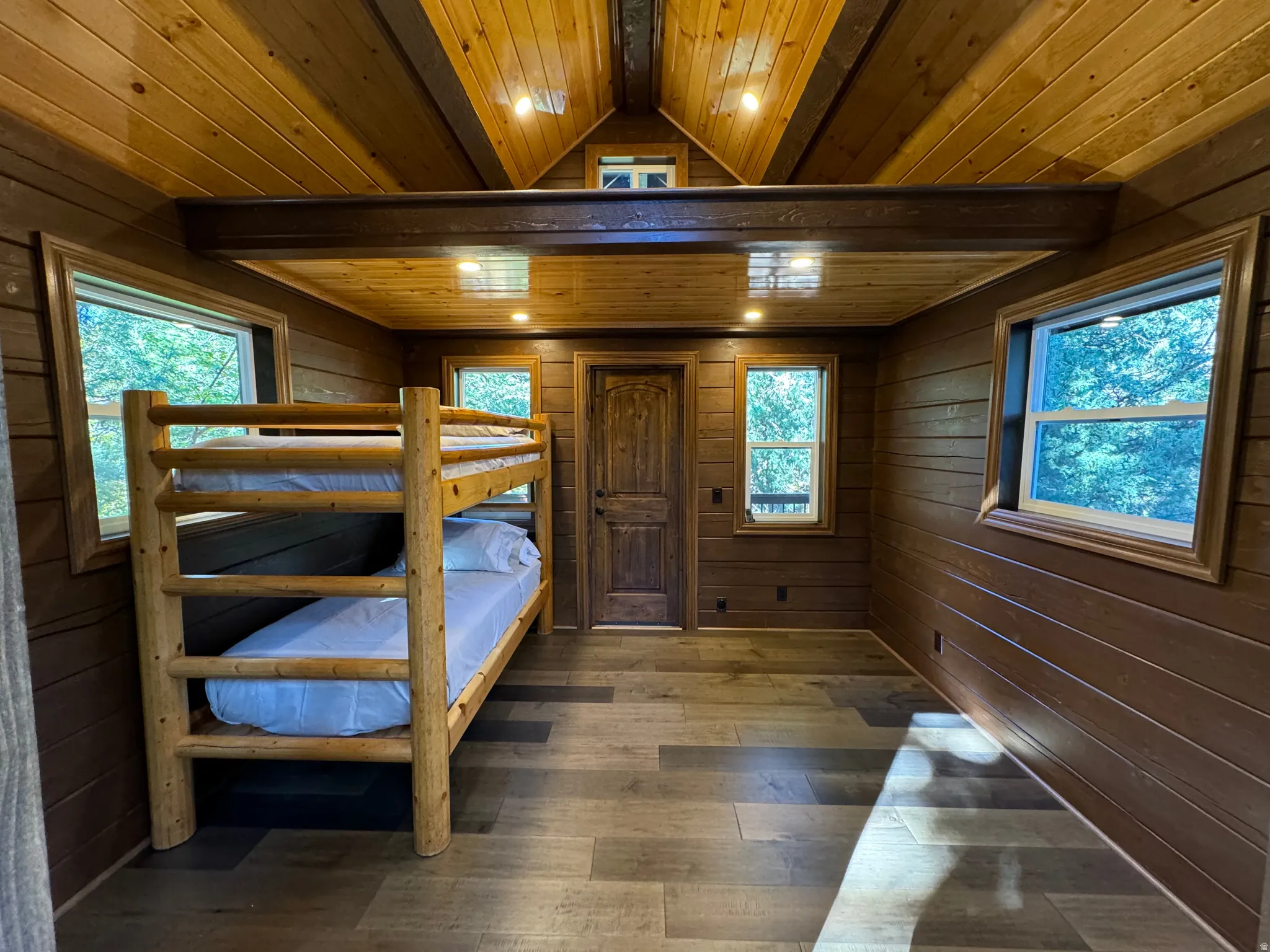 Bedroom featuring wooden walls, wood ceiling, dark wood-style floors, recessed lighting, and vaulted ceiling