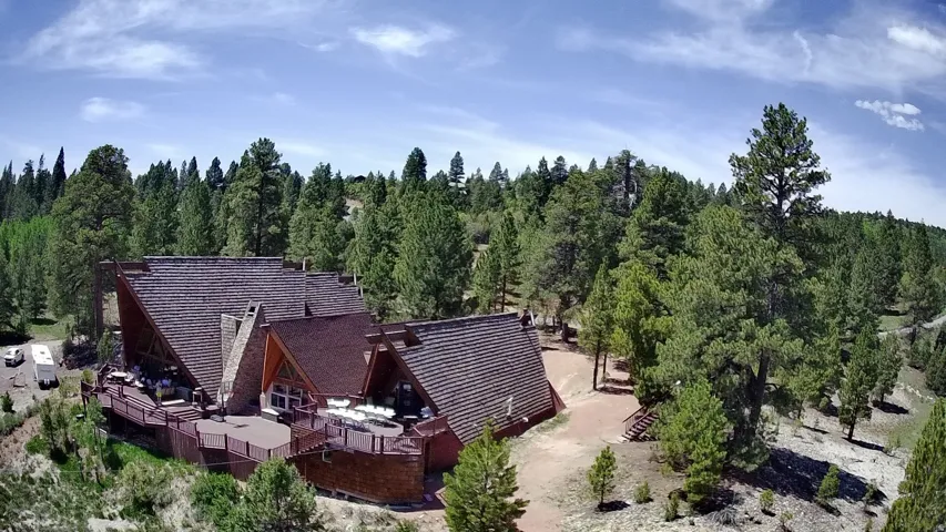 View from above of property featuring a heavily wooded area