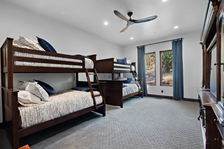 Bedroom with light colored carpet, recessed lighting, and ceiling fan