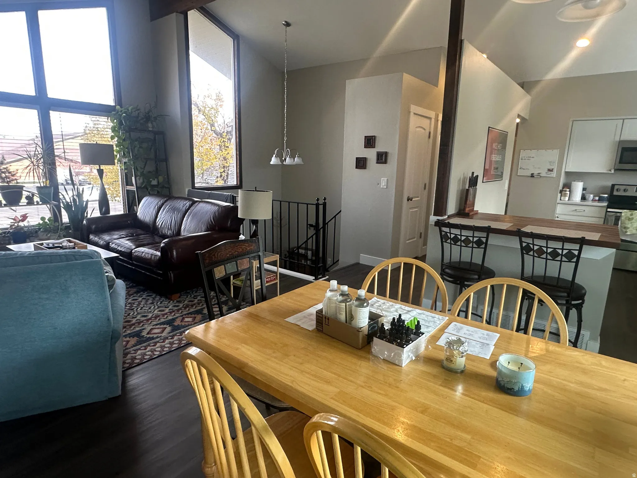 Dining area with dark wood-style floors and a chandelier