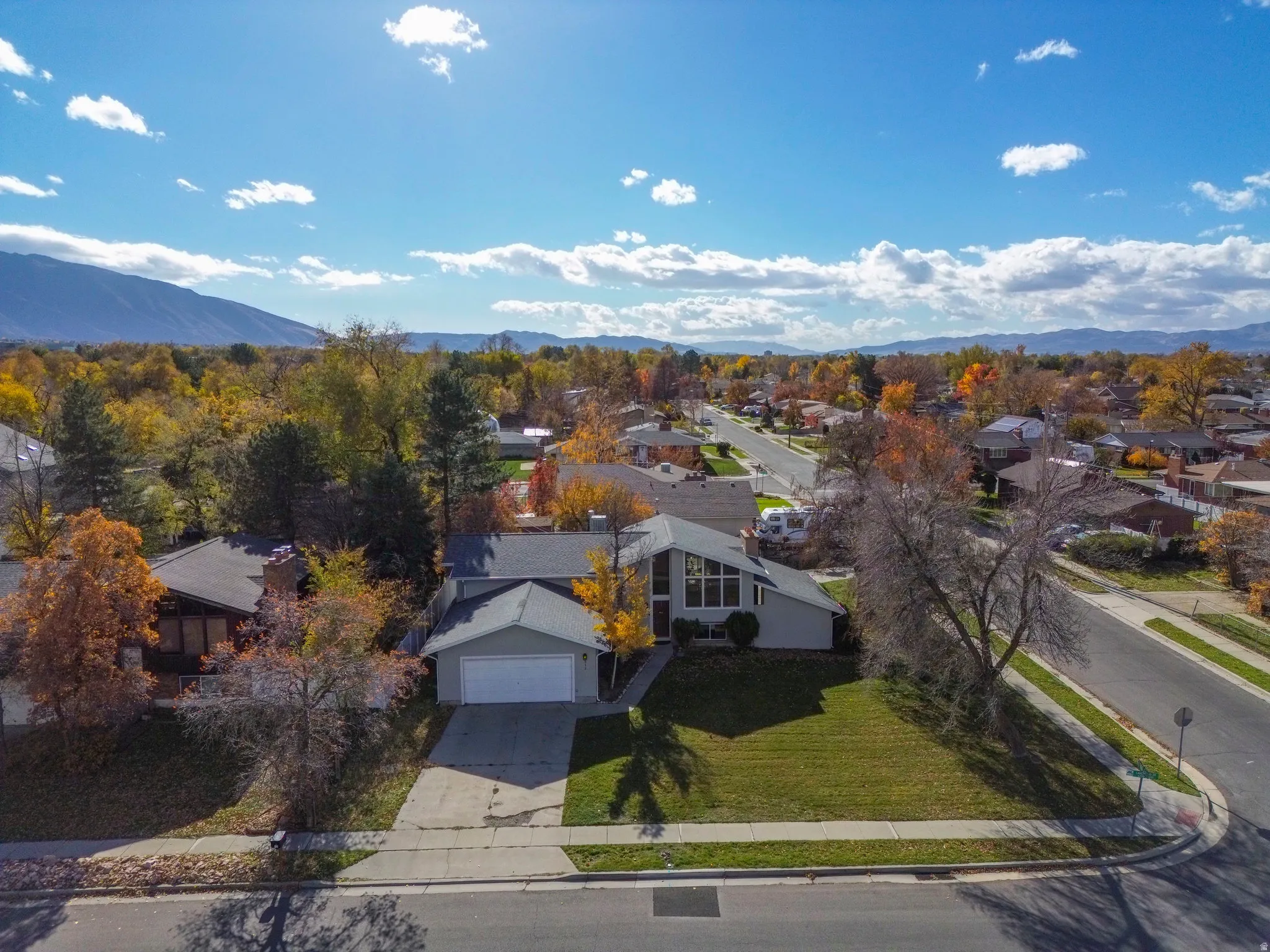 Aerial perspective of suburban area featuring a mountainous background