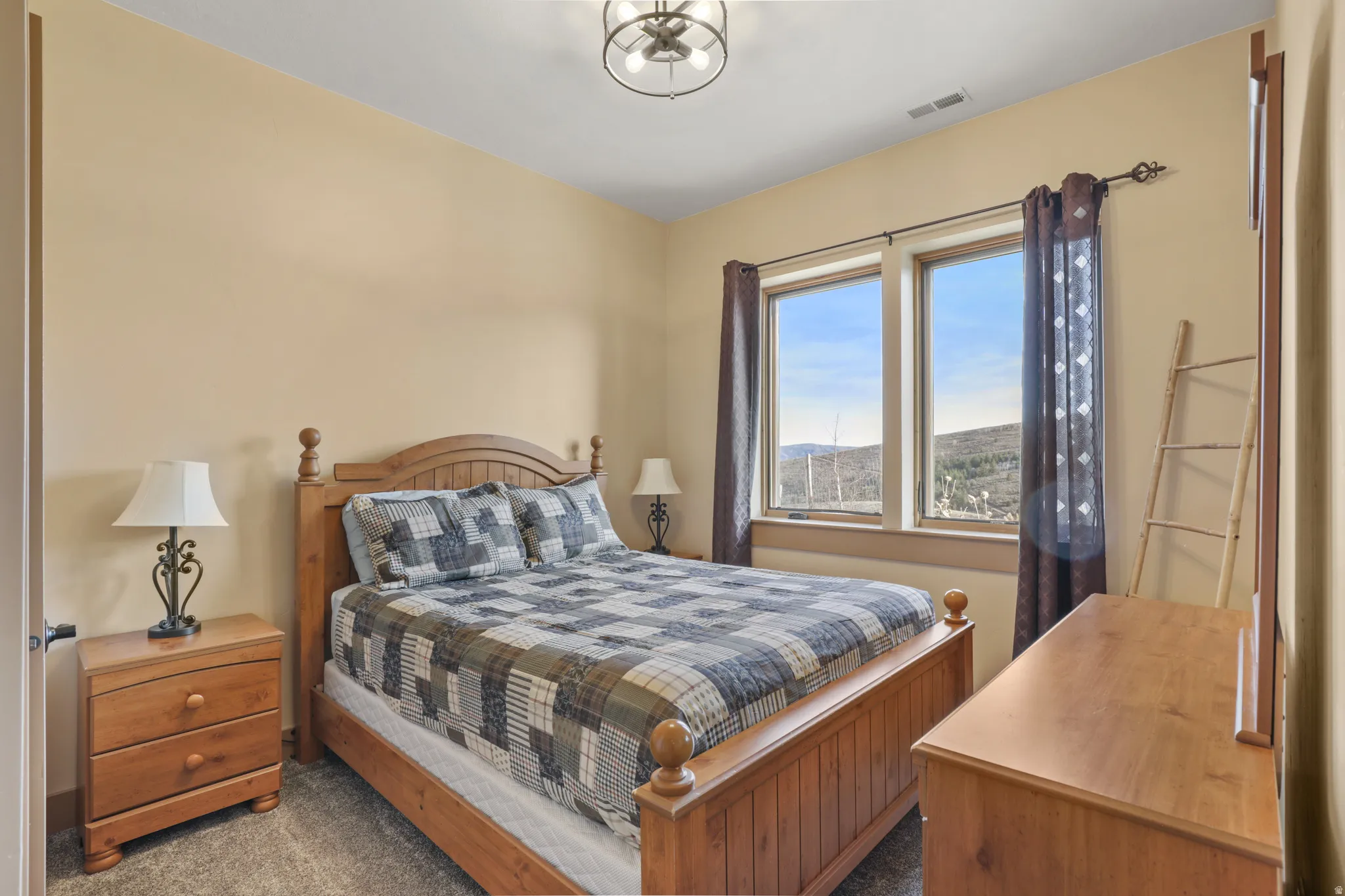 Bedroom featuring dark colored carpet and a mountain view