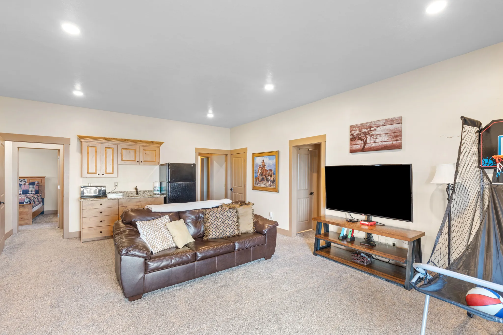 Living room with light colored carpet and recessed lighting