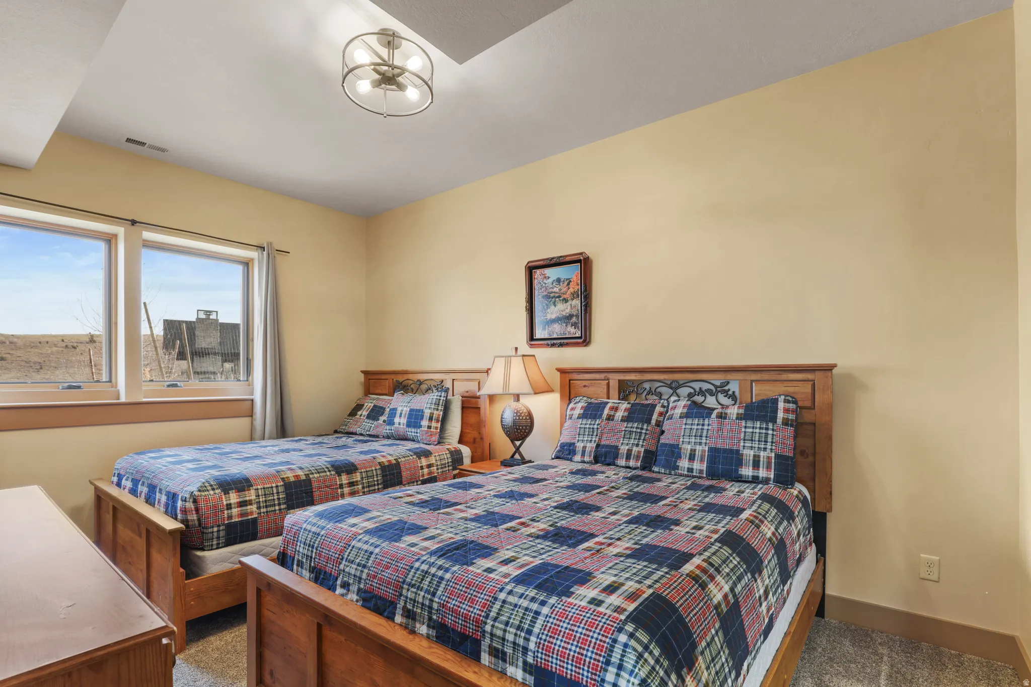 Bedroom with carpet flooring and a chandelier
