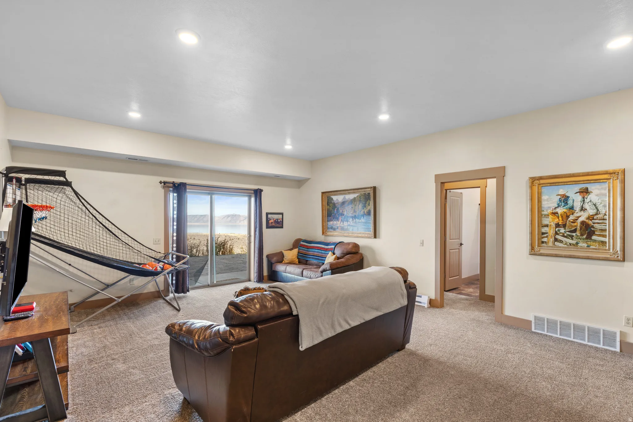 Living area with carpet floors and recessed lighting