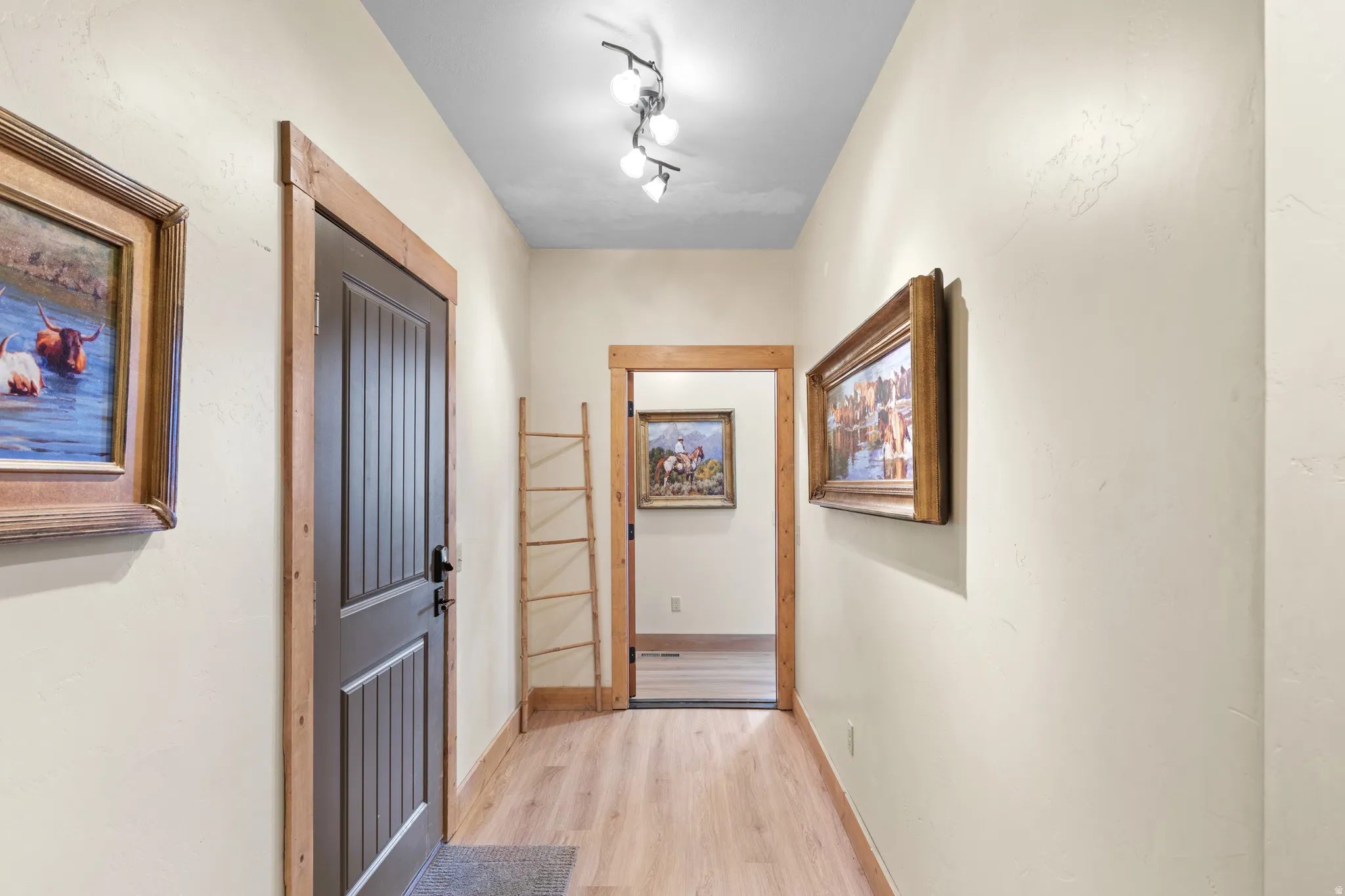 Corridor featuring light wood finished floors and baseboards