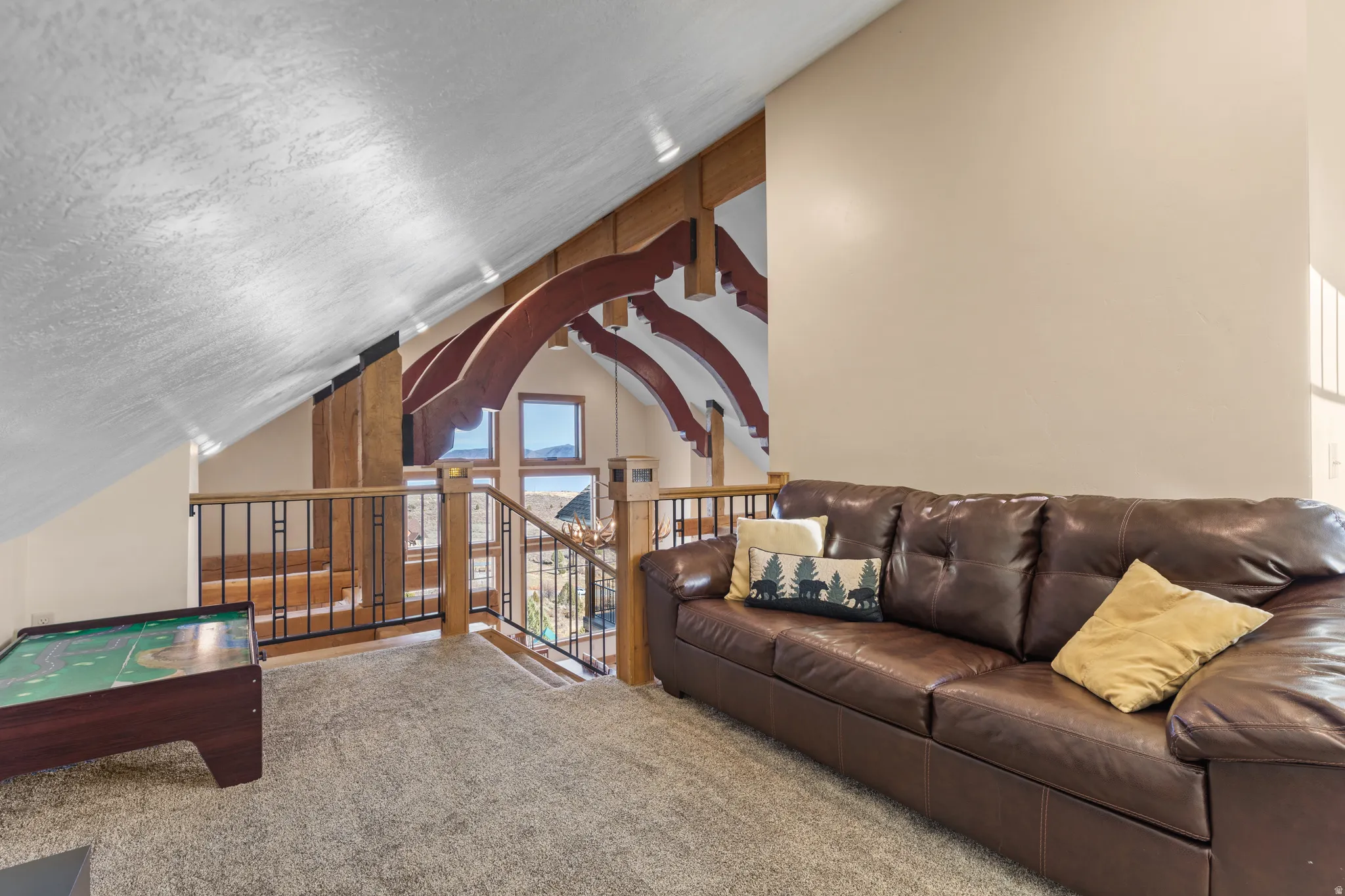 Carpeted living room featuring vaulted ceiling and a textured ceiling