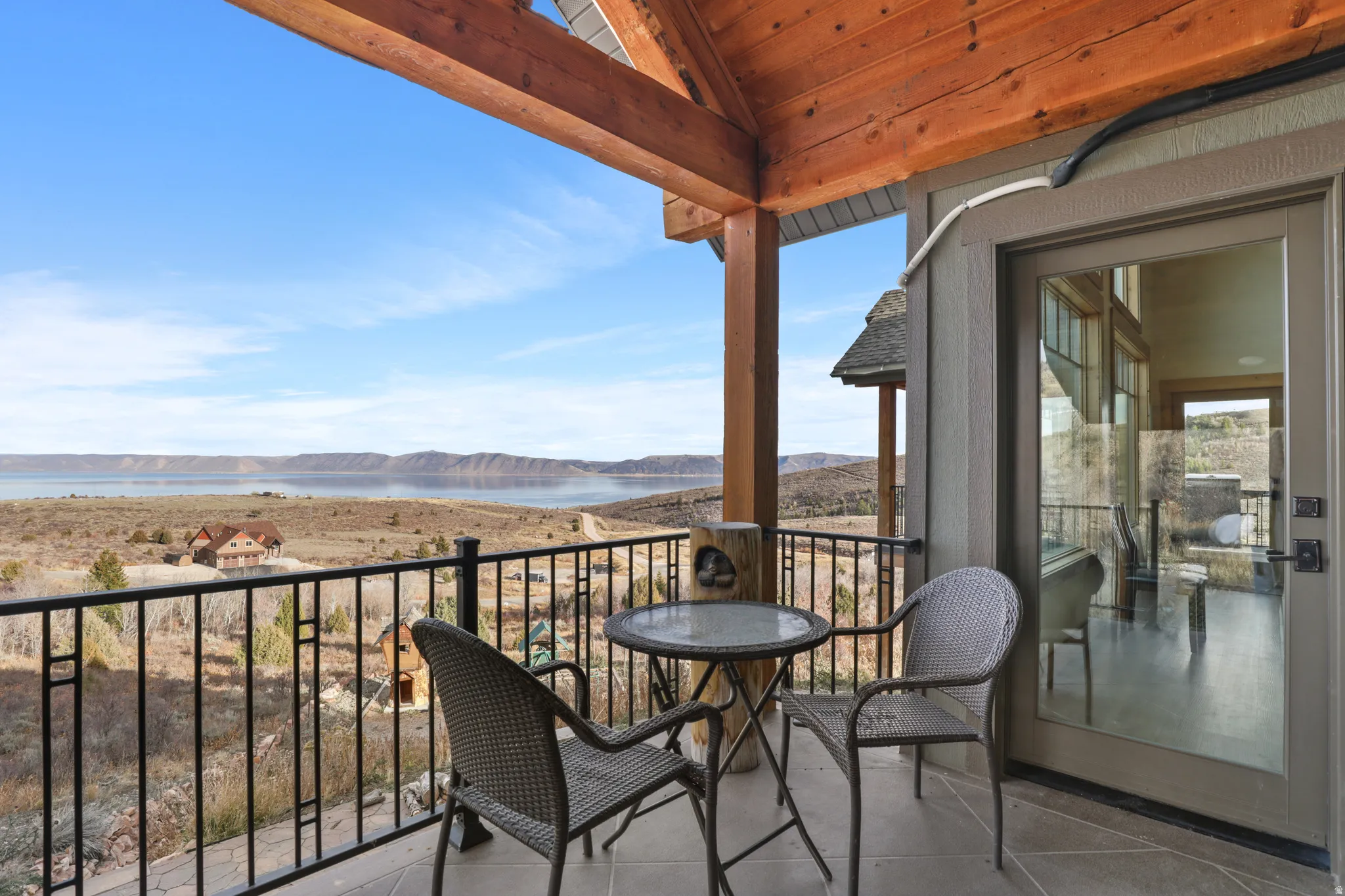 Balcony featuring a water and mountain view