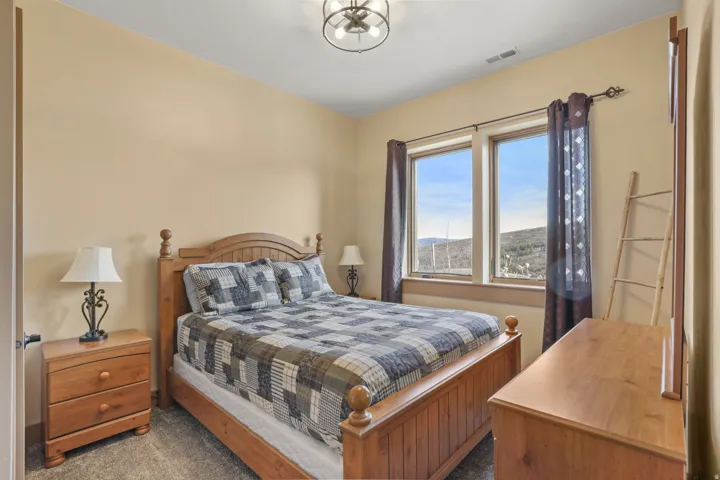 Bedroom featuring dark colored carpet and a mountain view