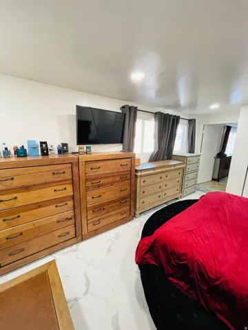 Bedroom with light marble finish flooring