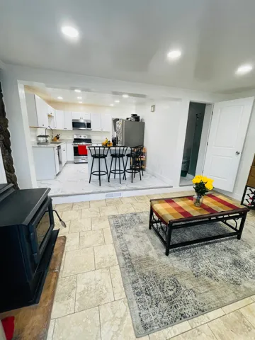 Living area with a wood stove and recessed lighting