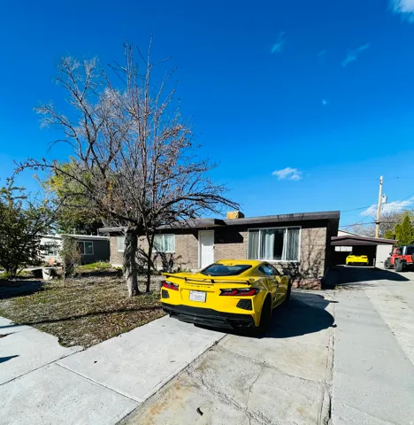 Ranch-style home featuring brick siding and a chimney
