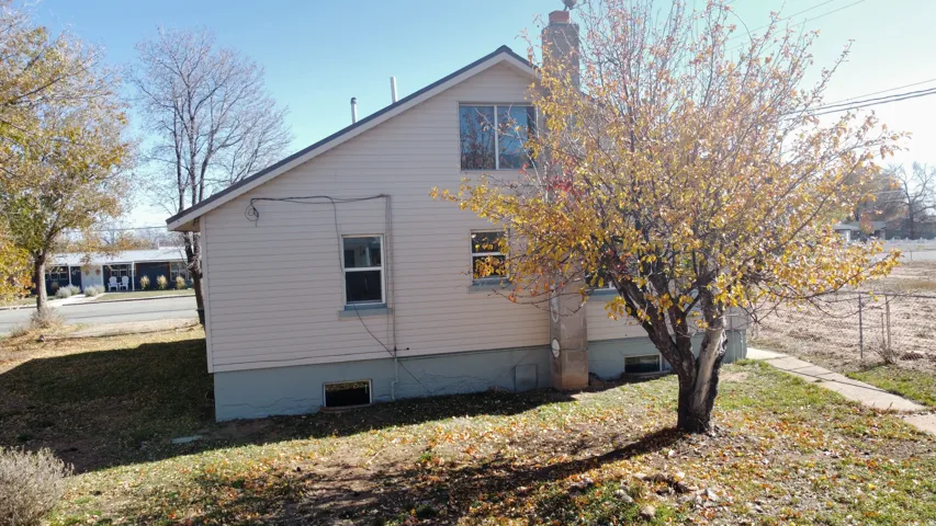 View of side of property with a yard and a chimney