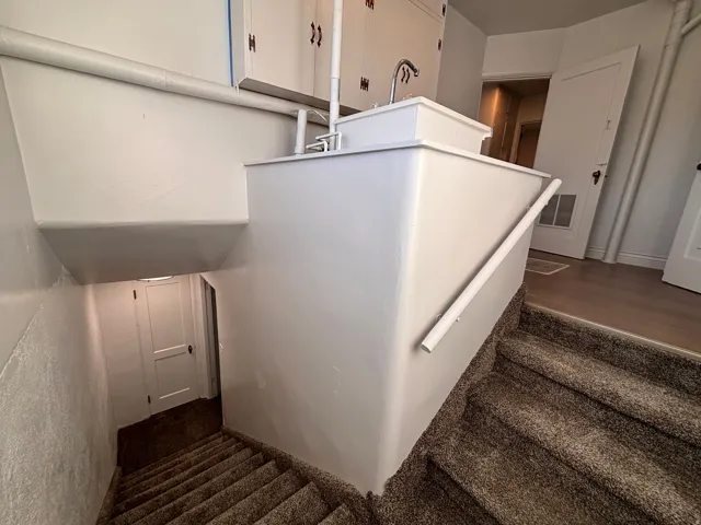 Stairs with carpet floors and baseboards