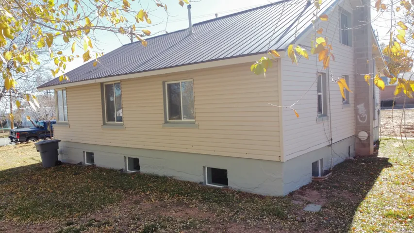 View of property exterior featuring a metal roof