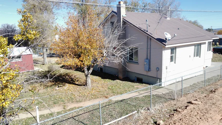 View of property exterior featuring a chimney and a metal roof