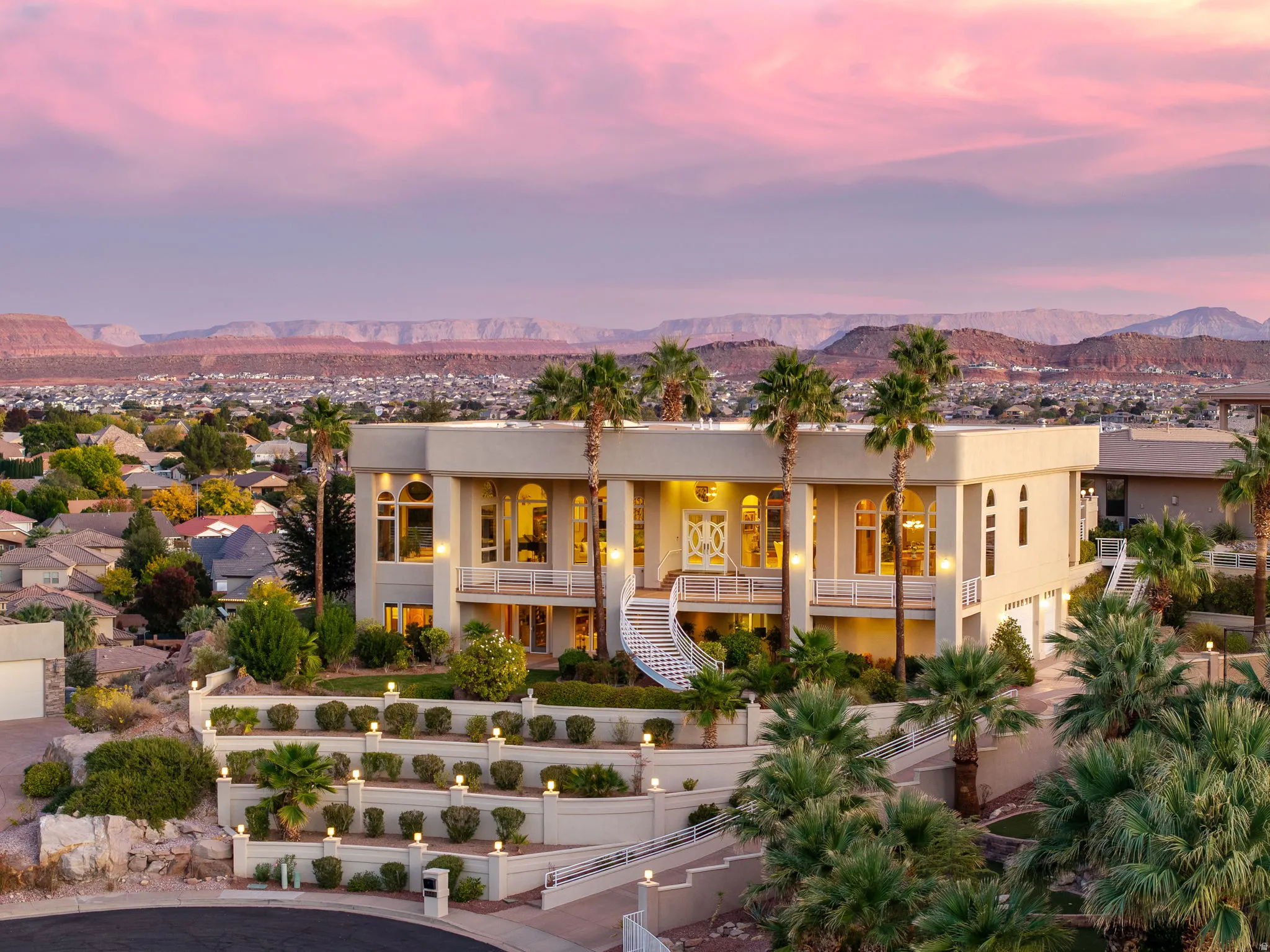 View of front of house with stairway, a fenced front yard, a mountain view, and stucco siding
