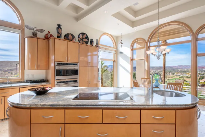 Kitchen with light stone counters and healthy amount of natural light