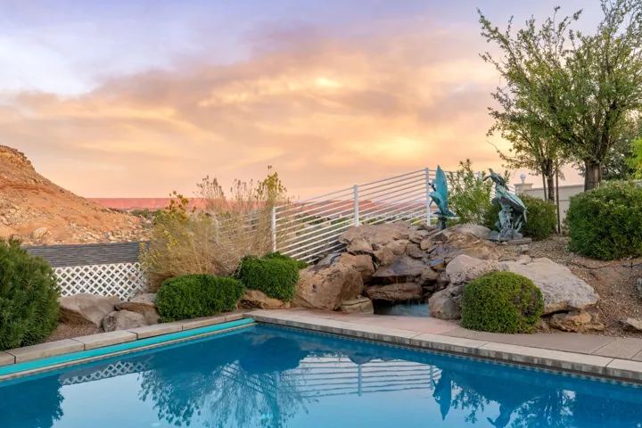 Pool at dusk featuring a patio area