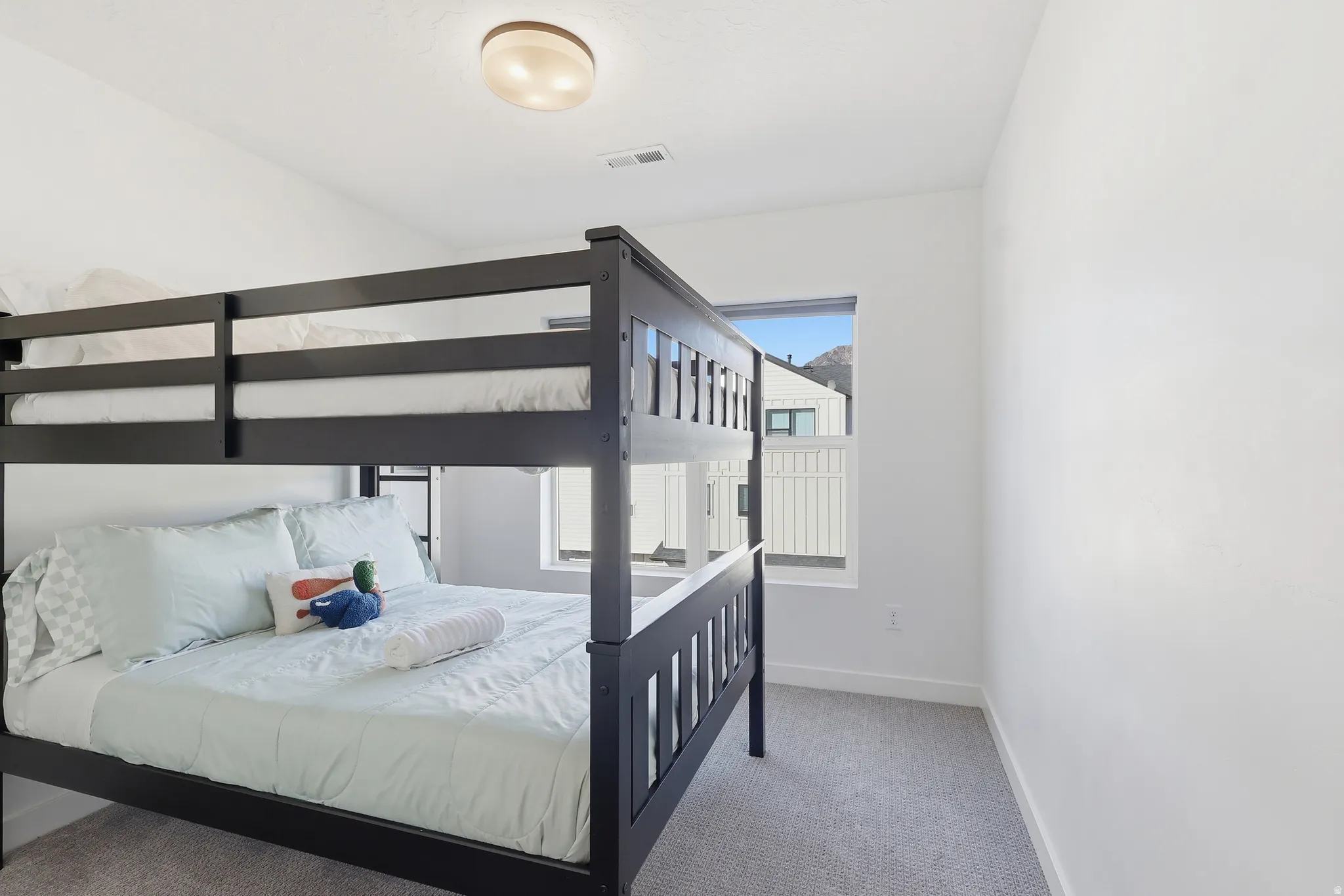 Bedroom with carpet floors and baseboards