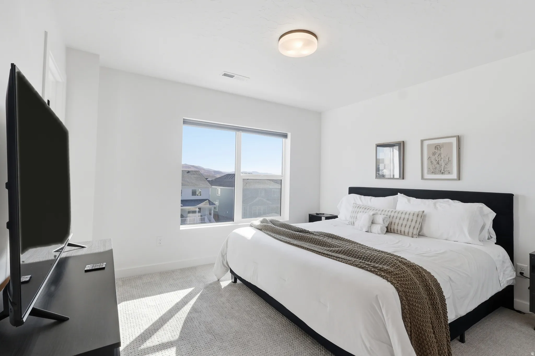 Bedroom with light carpet and baseboards