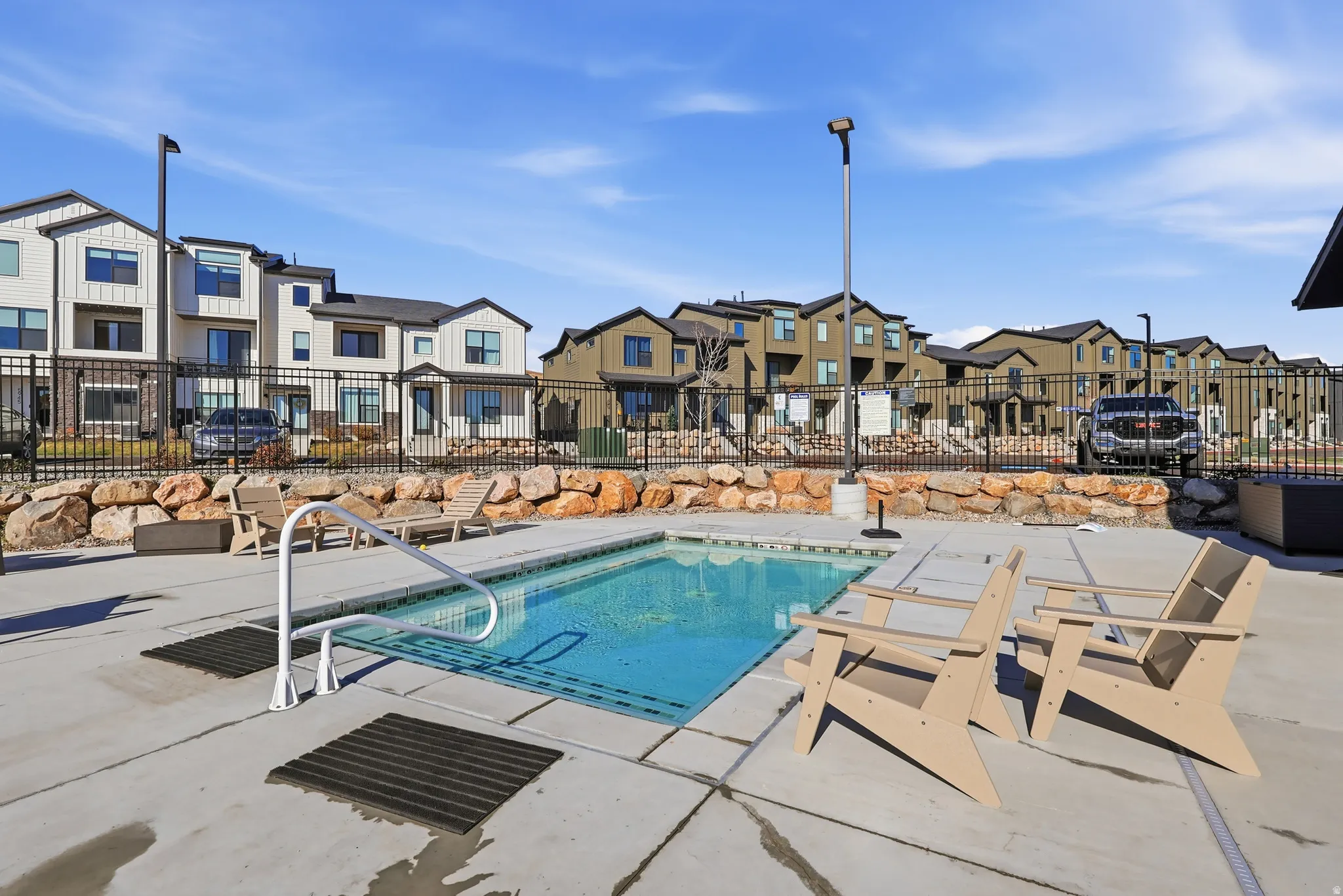 Community pool with a residential view and a patio area