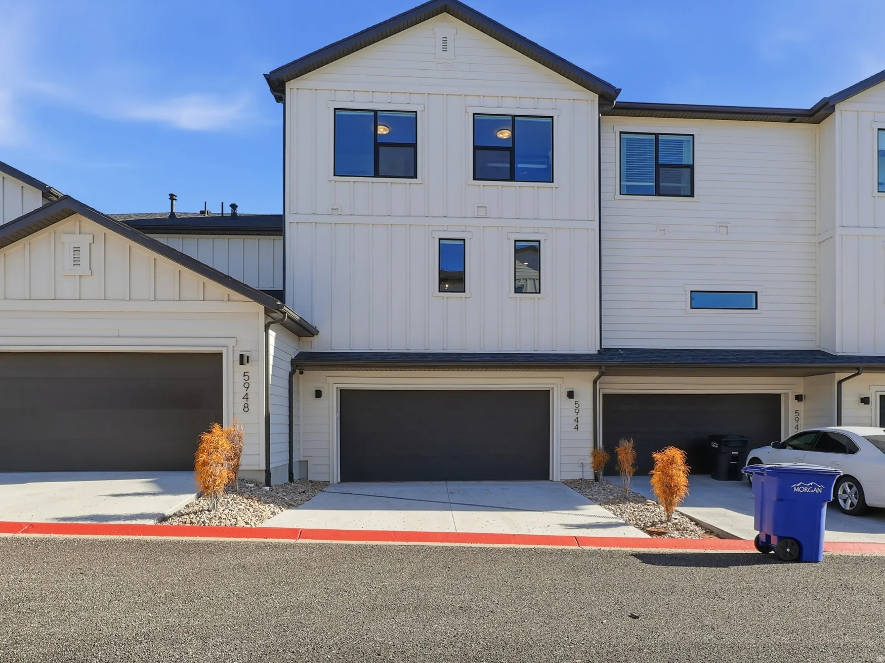 Modern farmhouse style home featuring board and batten siding, concrete driveway, and a garage